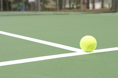 Tennis ball on the court line